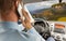 Businessman calling on smartphone and driving car