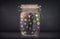 Businessman captured in a glass jar with colourful app icons con