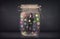 Businessman captured in a glass jar with colourful app icons con