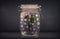 Businessman captured in a glass jar with colourful app icons con