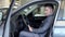 Businessman in a car salon. Man looking at the car