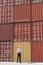 Businessman with cargo containers