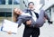 Businessman is carry his partner woman on hands because they are signed successful contract