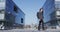 Businessman Carrying Backpack While Walking On Road by Office Buildings In City