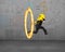 Businessman carrying golden euro sign jumping through fire hoop