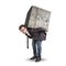 Businessman carrying a large and heavy stone on his back