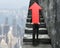 Businessman carrying red arrow sign climbing on stairs