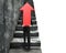 Businessman carrying red arrow sign climbing on stairs