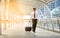 Businessman carrying a suitcase on passage of modern building