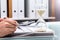 Businessman Checking Bill With Hourglass On Desk