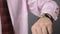 Businessman checking time on his watch, punctual office worker, close-up view