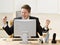 Businessman cheering at Desk