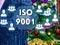 The businessman chooses ISO 9001 on the touch screen, the backdrop of the Christmas tree and decorations. Special toning .