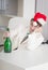 Businessman in Christmas cap with bottle at table