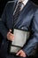 Businessman clasping briefcase