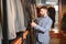 Businessman in classic vest against row of suits in shop