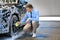 Businessman cleaning auto with sponge at car wash