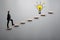 Businessman climbing steps towards light bulb