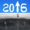 Businessman climbing on wooden ladder for 2016 arrow sign clouds