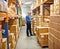 Businessman, clipboard and boxes in warehouse with inventory for quality control and freight distribution. Senior