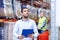 Businessman with clipboard at warehouse