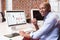 Businessman with computer at office desk