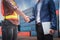 Businessman and Container Shipping Worker Handshake Together for Cooperation Shipment in Logistic Warehouse, Business Partnership