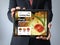 Businessman with cooking blog on a tablet