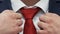 Businessman is Correcting Red Tie On A White Shirt