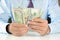 Businessman counting money,US dollar (USD) banknotes