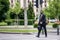 Businessman cross the street outdoor wearing a gas mask on the face.