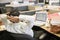 Businessman in cubicle with laptop