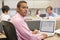 Businessman in cubicle with laptop