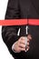 A businessman cutting a scarlet satin ribbon