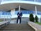 A Businessman descends stairs gracefully in sharp attire Each step showcases the Businessman's poise. Background