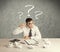 Businessman at desk with question mark