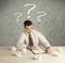 Businessman at desk with question mark