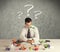 Businessman at desk with question mark