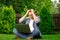Businessman in desperation. Upset man sits on grass with laptop grabbing head