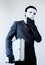 Businessman in disguise mask stealing a confidential suitcase