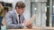 Businessman Doing Paperwork, Reading Documents in Office