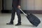 Businessman drag luggage or suitcase walking to the hotel lobby