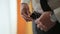 Businessman dressing leather belt. Close up with curtains on background