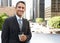 Businessman Drinking Takeaway Coffee Outside Office