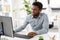 Businessman with earphones and computer at office