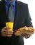 Businessman eating junk fast food