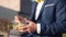 Businessman eating salad outdoors. Unrecognizable person. Hands view.