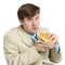 Businessman eats a sandwich isolated on a white