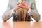 Businessman Elbows on Desk Hands Folded