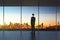 Businessman in empty office looking at beautiful skyline